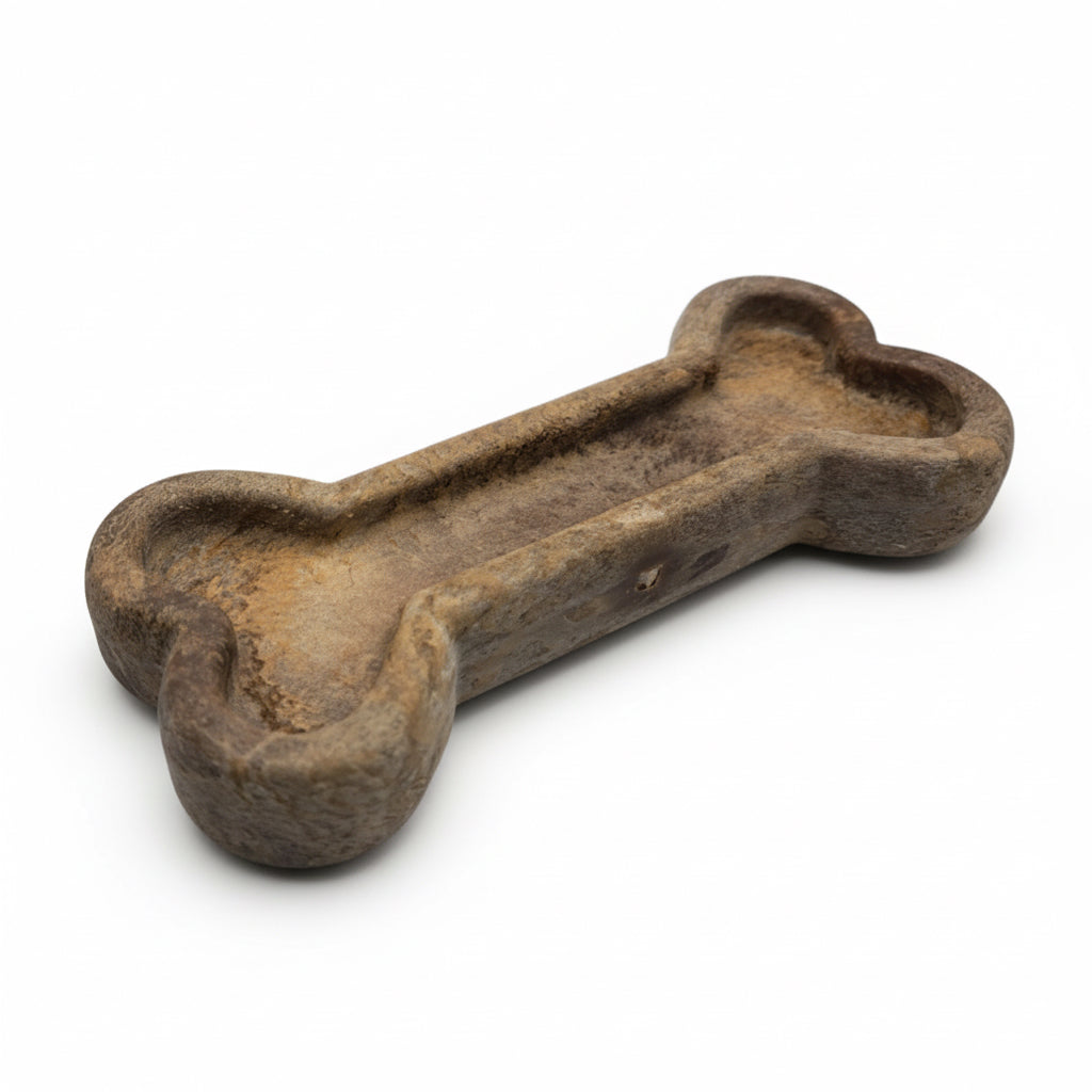 Dog bone-shaped toy made of a natural material on a white background