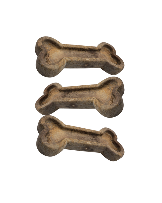 Three bone-shaped dog toys on a white background